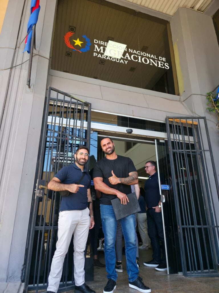 Osher with client celebrating Paraguay residency process at Dirección Nacional de Migraciones, Asunción