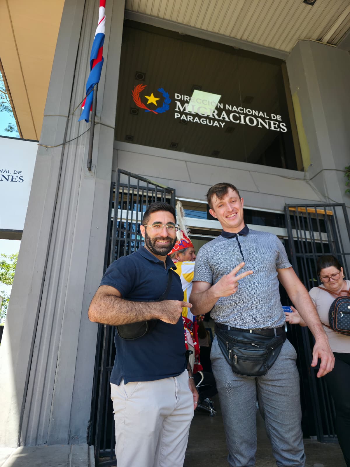 Osher with client at Paraguay Migraciones office after residency application success